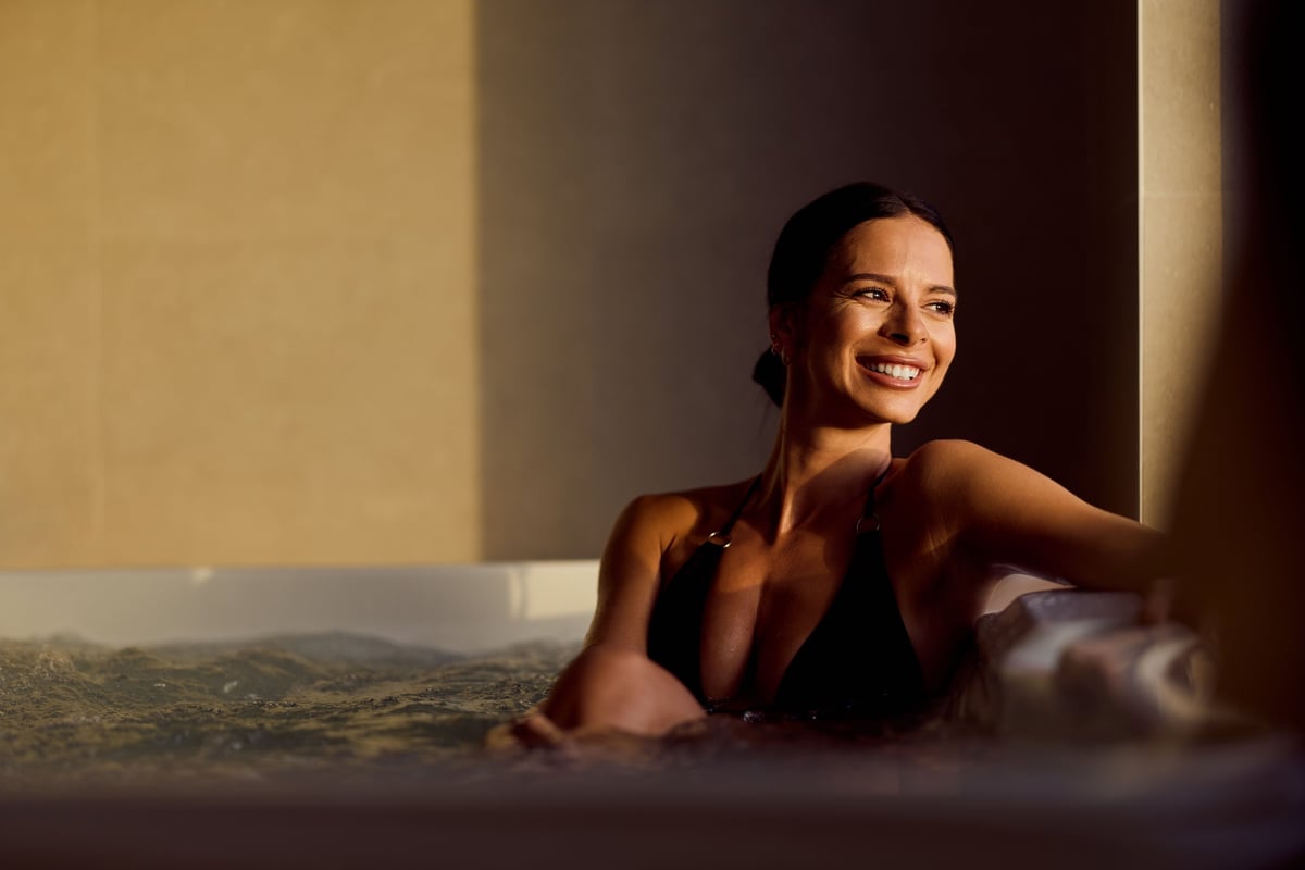 Outdoor hot tub on a patio in warm sunlight