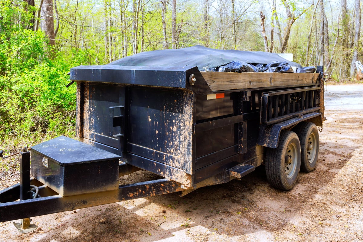 Dump trailer parked and ready for a junk removal job