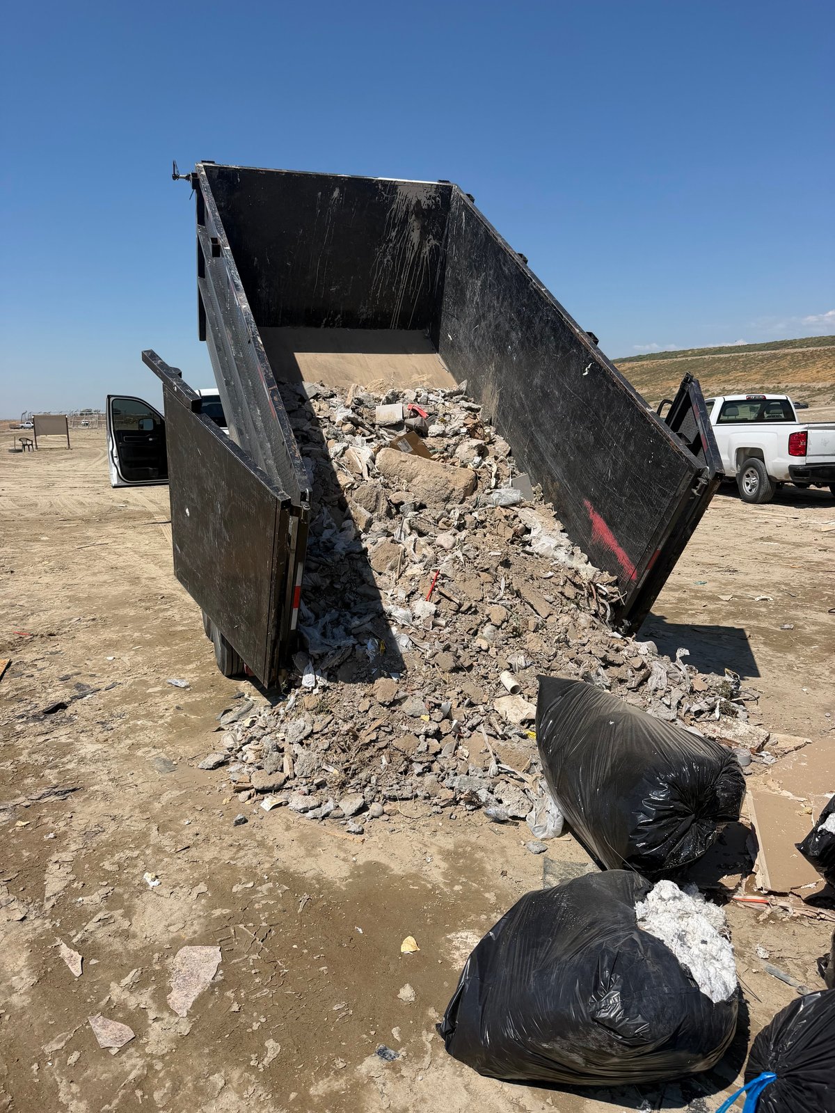 Shed and outbuilding materials staged for removal