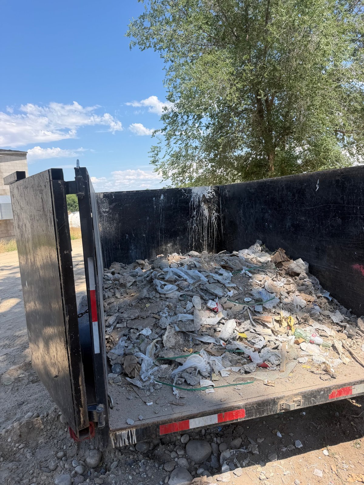 Open truck bed filled with construction debris and rubble